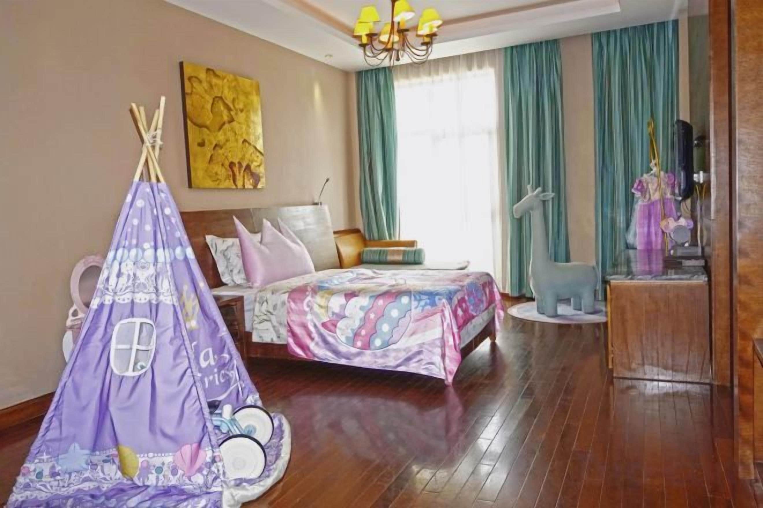 A bedroom with a bed, a tent, a dresser, and a window with curtains.