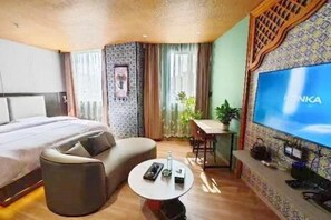 Relax in a stylish room with a large bed, sofa, and flat-screen TV.