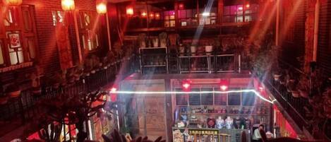A multi-level restaurant with traditional decor, including lanterns and wooden elements.
