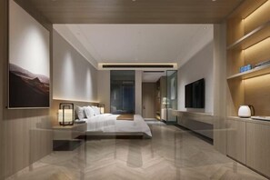 Relax in a serene space with a large bed, bedside table, and abstract art.