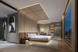 Un dormitorio moderno con una cama grande, mesitas de noche, una lámpara de pared y un ventanal con vistas.