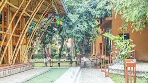A bamboo structure with a tiled pathway leading to a staircase. - Jungle Adventure World Hotel Pvt. Ltd (Sauraha)