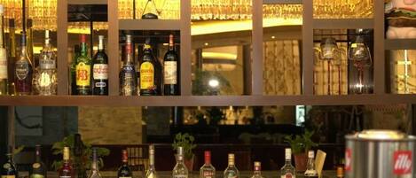 A bar area with shelves of liquor bottles and glasses.