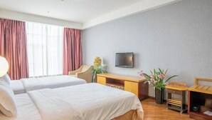A hotel room with two beds, a desk, a television, and a window with curtains. - Federal Hotel (Meizhou)