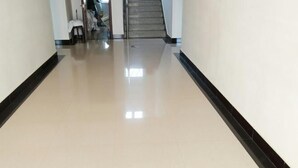 A clean, well-lit hallway with a shiny floor, leading to a staircase. - Bingyugou Jiahua Business Hotel (Zhuanghe)