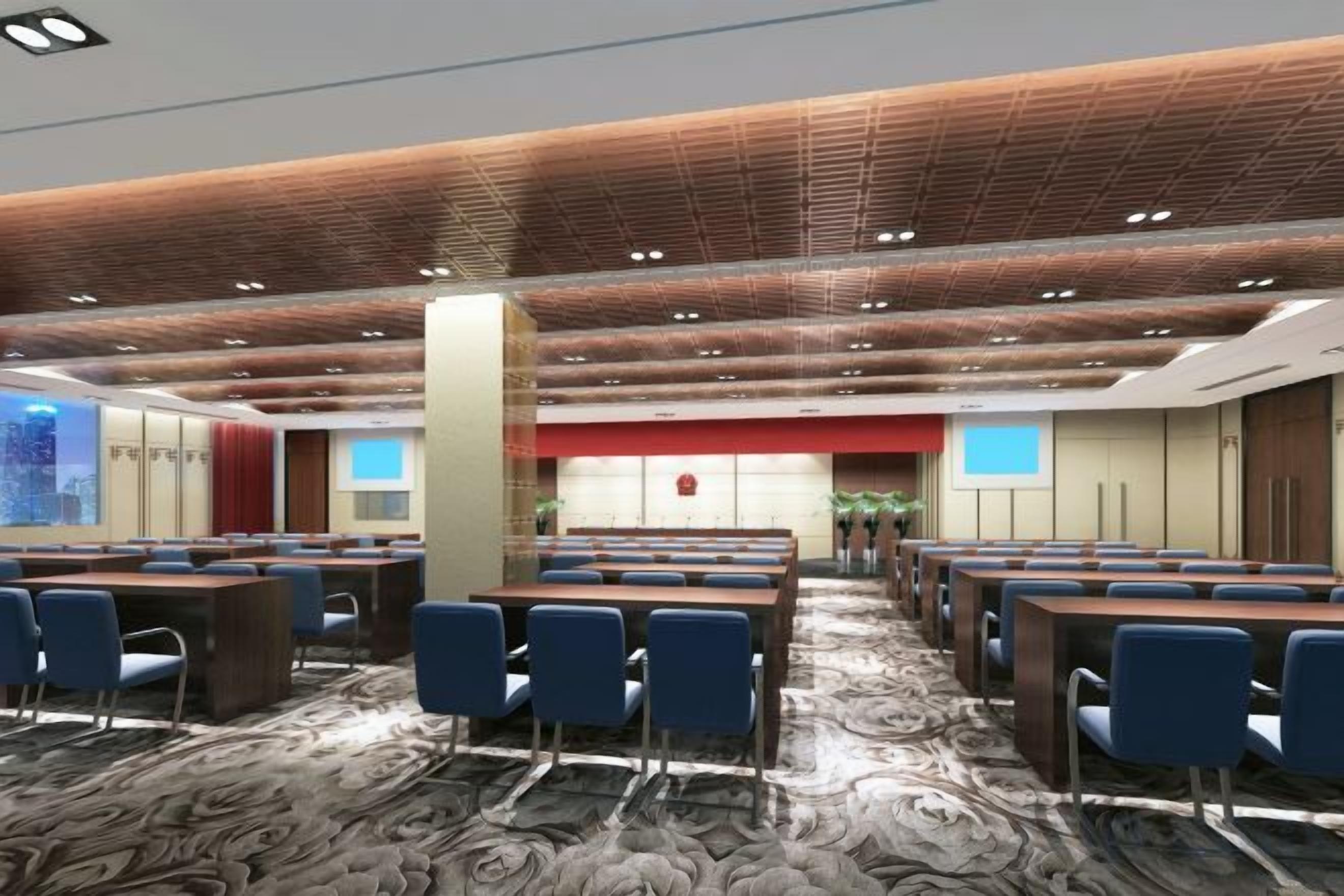 A conference room with multiple tables and chairs, a patterned carpet, and a modern ceiling design.
