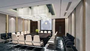 A modern conference room with a large rectangular table, multiple chairs, and a projector screen. - Qingtengyuan Hotel (Binzhou)