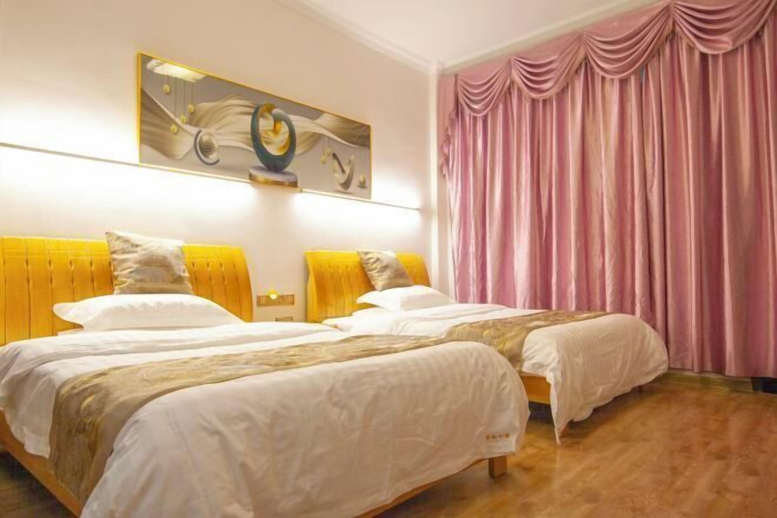 A hotel room with two beds, a large painting on the wall, and a pink curtain.