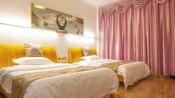 A hotel room with two beds, a large painting on the wall, and a pink curtain.