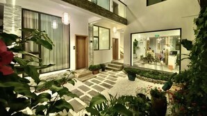 A modern building with a courtyard, large windows, and indoor plants. - ayan house (Dali City)