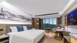 A modern hotel room with a large bed, a desk, and a view of the cityscape. - LIZ International Hotel Guangzhou Olympic Sports Center International Financial City Branch - Free Shuttle Bus to Canton Fair Complex During Canton Fair Period (Guangzhou)
