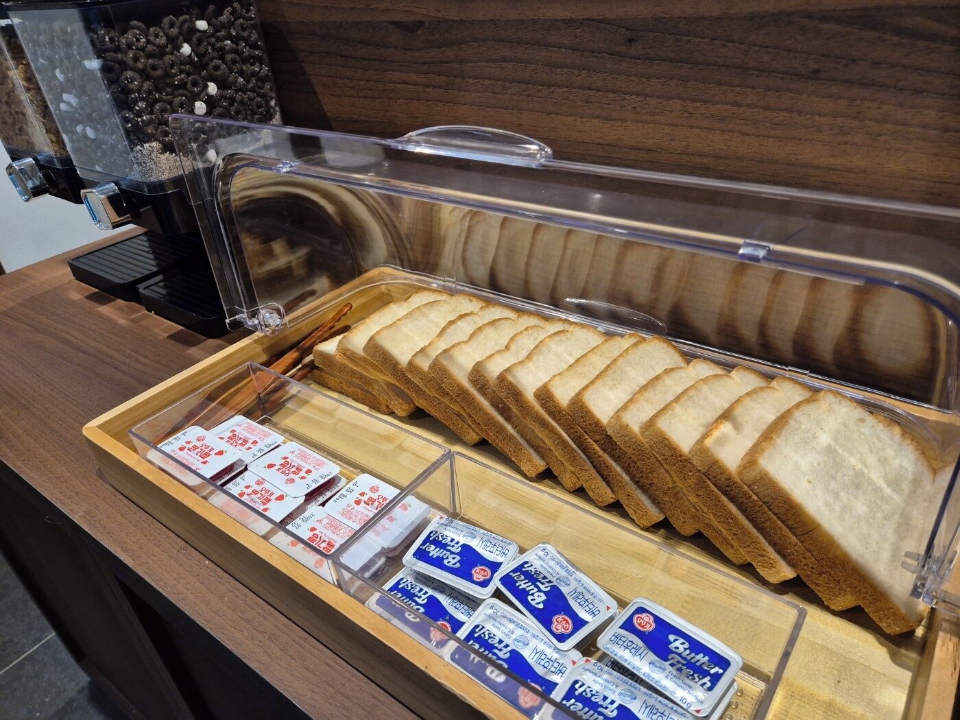 A buffet with sliced bread and butter spreads.