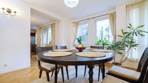 A dining area with a round table, chairs, and a central decorative bowl.
