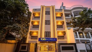 A multi-story hotel with a modern facade, illuminated entrance, and a sign reading "fabHOTELS". - Fabexpress Prime Inn (Prayagraj)