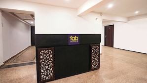 A hotel reception desk with a sign reading "fab hotels". - Fabexpress Prime Inn (Prayagraj)