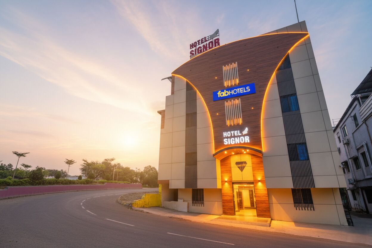 A modern hotel with a curved facade, a prominent sign for 'Hotel Signor', and the 'fabHOTELS' logo.