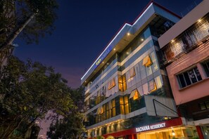 A multi-story building with a modern facade, featuring a prominent sign for 'fab hotels' and a lower sign for 'Rachana Residency.' - Fabhotel Rachana Residency (Pune)