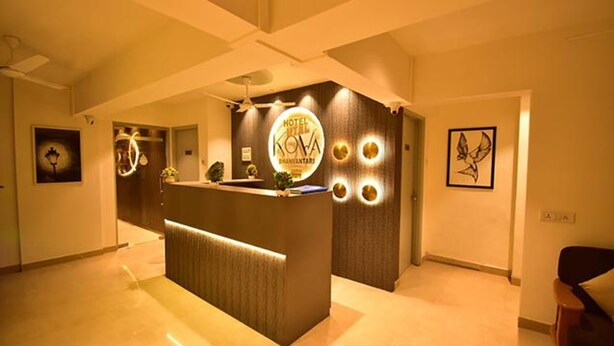 A hotel reception desk with a modern design, a logo, and a reception area.