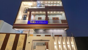 A multi-story hotel with a prominent sign reading 'fabHOTELS' on the ground floor. - Fabhotel Hridyam Madhuram (Faizabad)