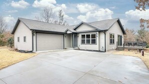 A single-story house with a garage, a covered patio, and a driveway.