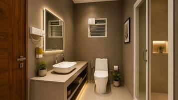 A modern bathroom with a sink, toilet, and shower.