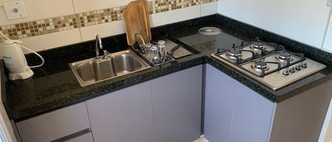 Fridge, microwave, stovetop, coffee/tea maker
