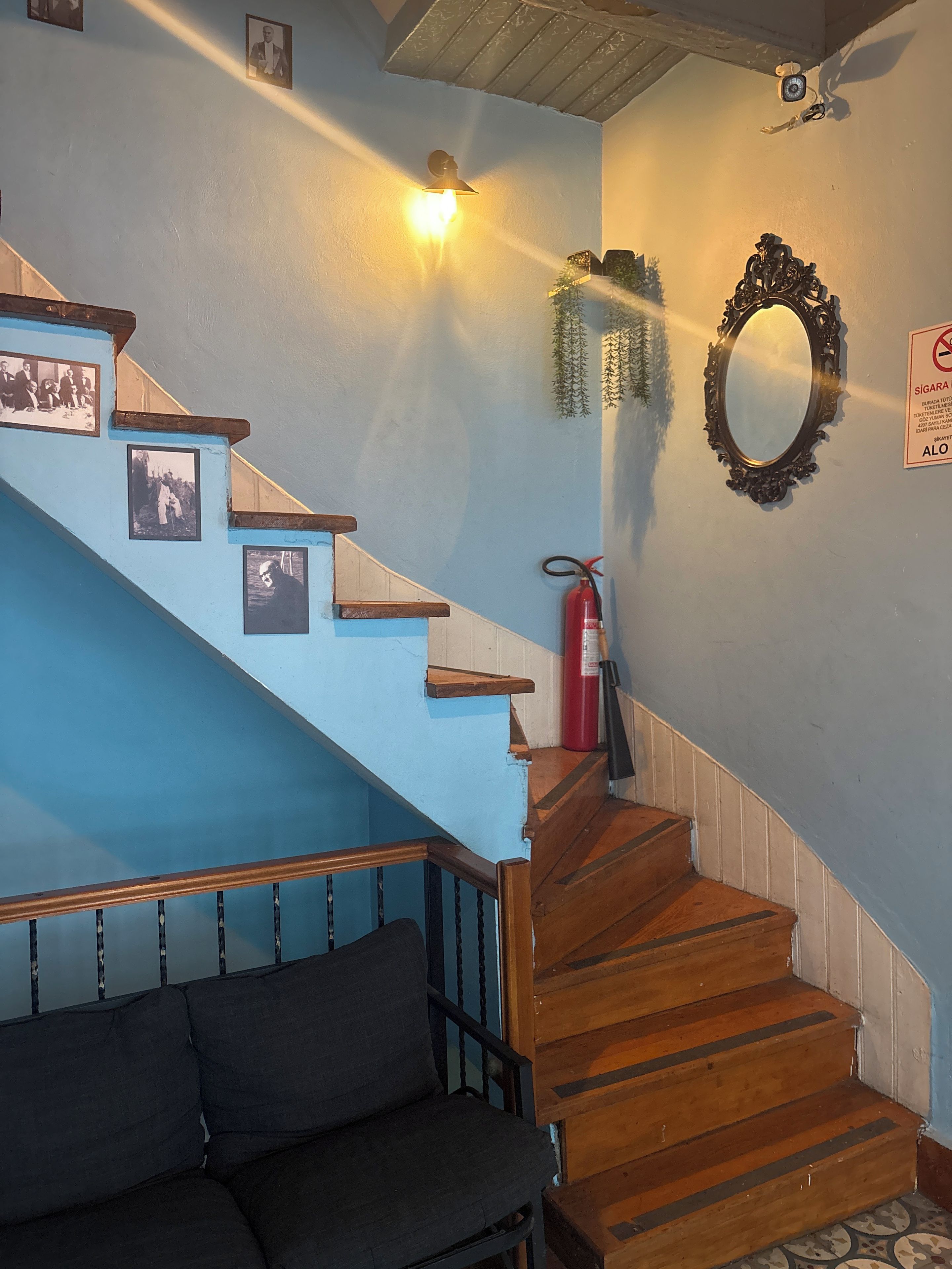 A staircase with wooden steps and a blue wall.