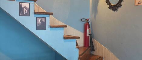 A staircase with wooden steps and a blue wall.