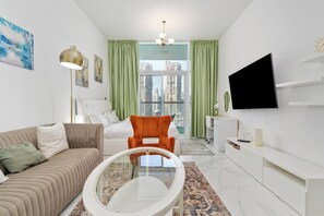 Deluxe Studio, Canal View | Living area | 55-inch Smart TV with cable channels - Studio with Canal Views by Bespoke (Dubai)
