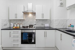 Fridge, stovetop, cookware/dishes/utensils, spices - Tigris - Cosy Studio Flat (Warrington)