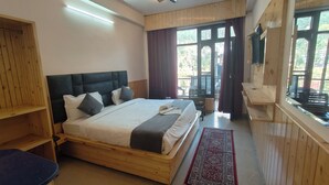 A wooden-framed bedroom with a large bed, a TV, and a view of the outdoors. - HOTEL CLOUD HEIGHT (Dharamshala)