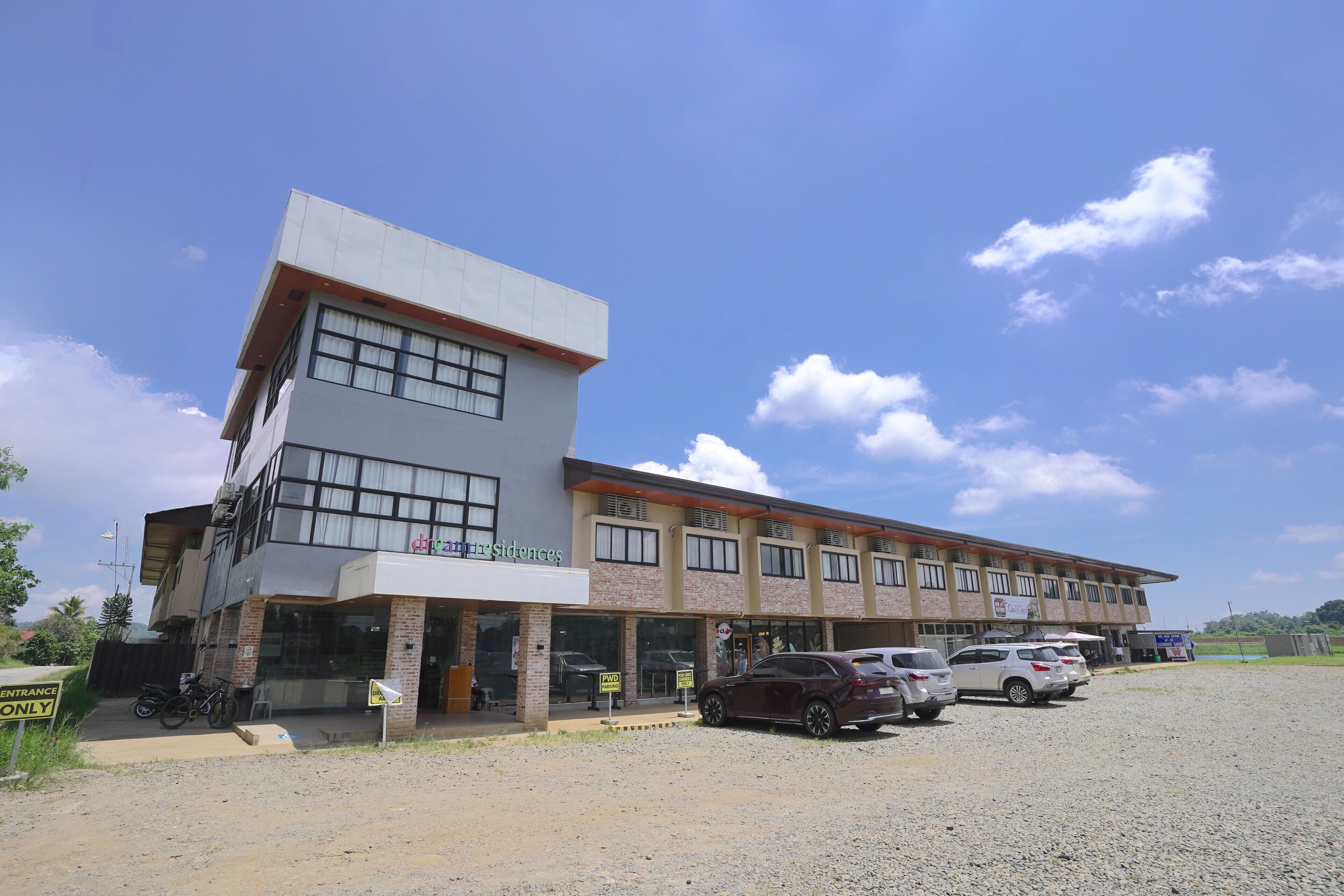 A two-story building with a sign for 'Dream Residences'.