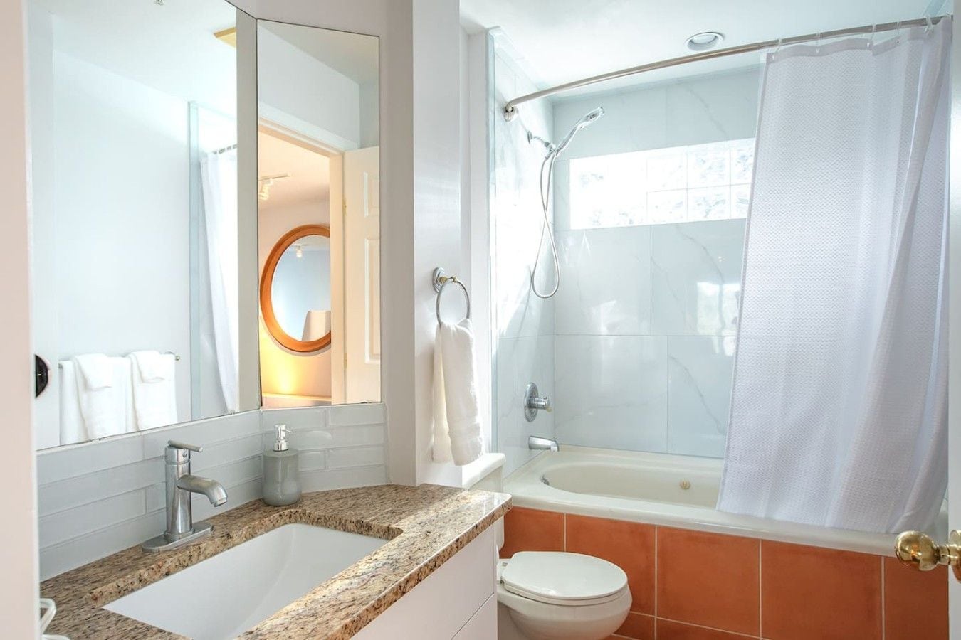 A bathroom with a sink, toilet, and shower.