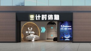 Une façade moderne avec deux entrées, chacune étant agrémentée d’une enseigne arborant le logo d’un panda et l’inscription « Faites une sieste ».