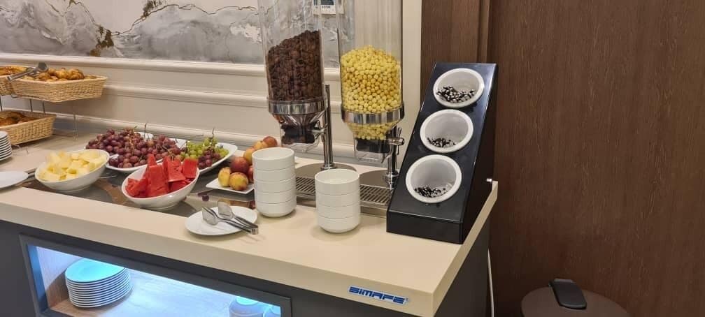 A buffet setup with various food items and condiments.