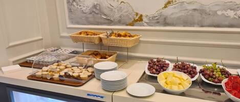 A buffet setup with various food items and serving dishes.