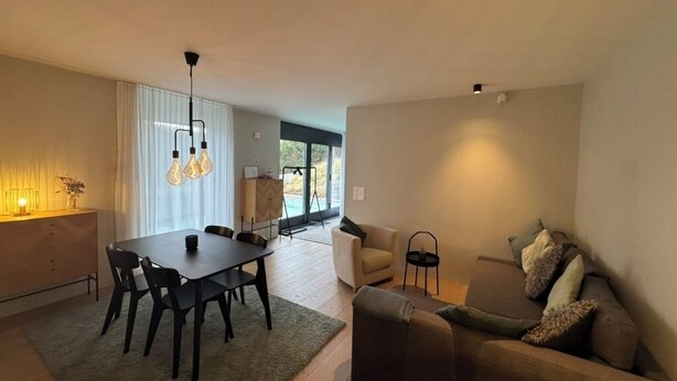 A modern living room with a dining area, a sofa, and a coffee table. - Beautiful apartment in Rüschlikon Zurich (Rüschlikon)