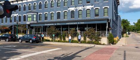 A two-story building with a sign reading 'Depot Town' and a restaurant named 'Thompson & Co.'