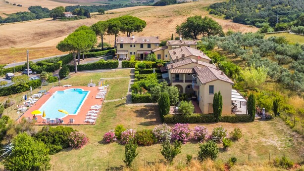 A villa with a swimming pool, surrounded by lush greenery and olive groves. - Le Farsiche by Interhome (Castellina Marittima)