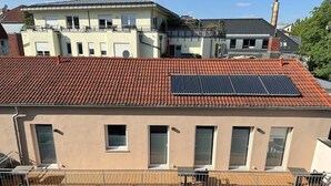 A residential building with a red-tiled roof, solar panels, and a balcony with a metal railing. - Spacious vacation apartment in Dresden Neustadt - your stylish temporary home (Dresden)