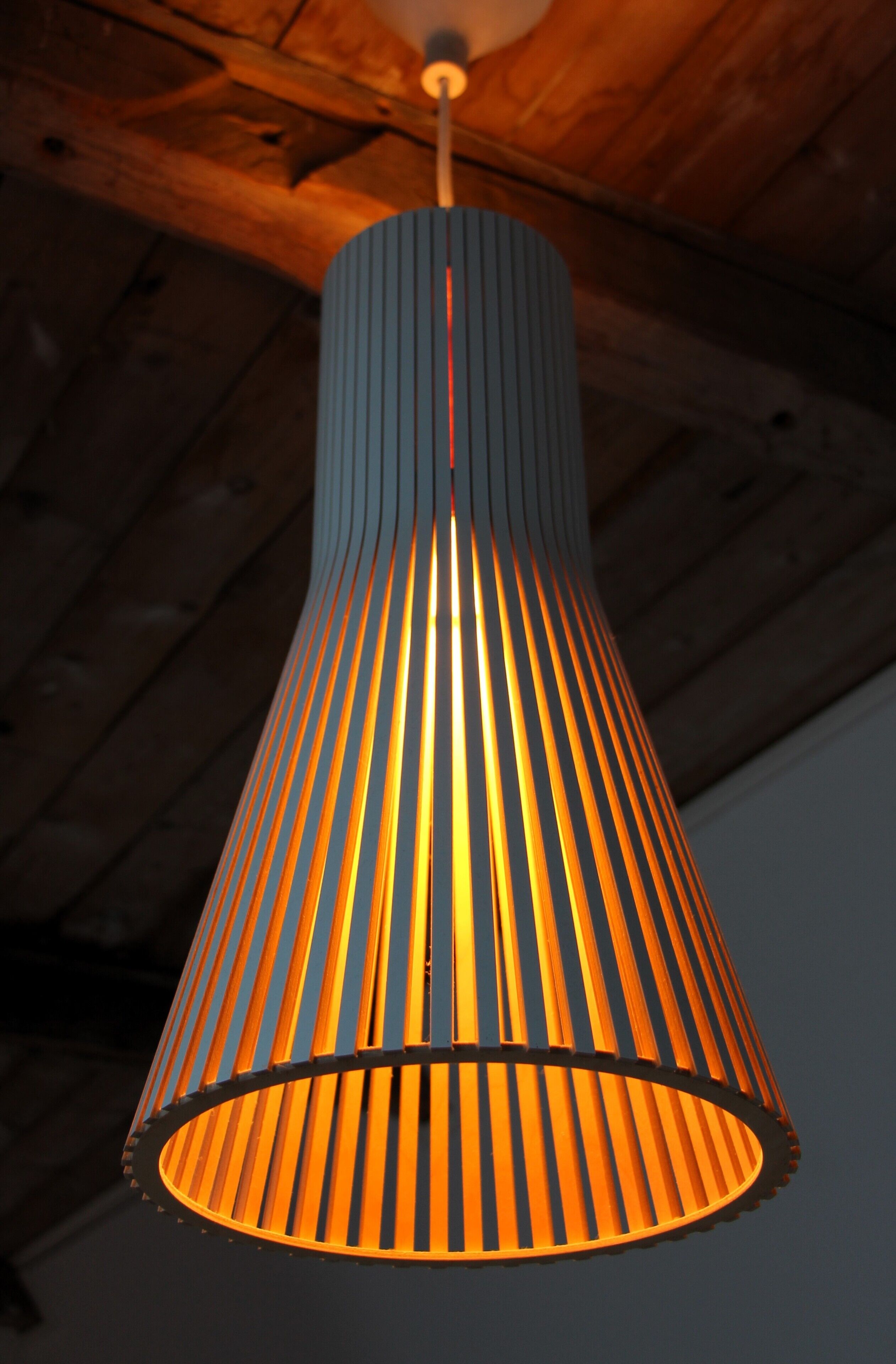 A hanging pendant light with a ribbed design.