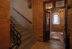 A staircase with a handrail leading to a doorway with a window. - 2-Bedroom, 2-Bathroom Apartment in the Historic Center - Freedom Suites (Parma)