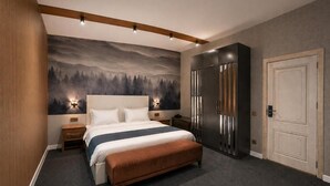 Un dormitorio con una cama grande, un armario, una mesita de noche y un mural en la pared.