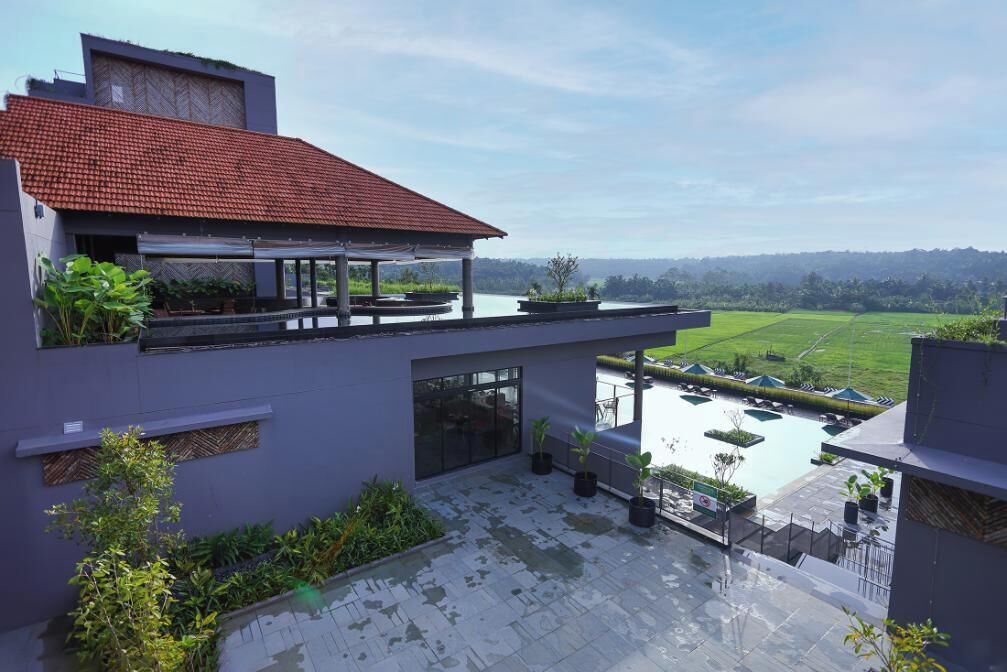 Une maison moderne dotée d’une terrasse sur le toit, d’une piscine et offrant une vue sur un paysage verdoyant.