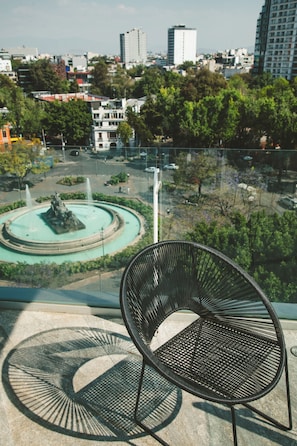 Enjoy the serene ambiance of this urban retreat, where a soothing fountain and lush greenery create a peaceful atmosphere.