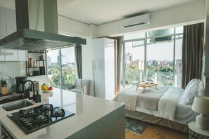 Relax in this stylish room with a large bed, seating area, and city view.