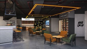 A modern cafe interior with seating, a counter, and a staircase. - Mcsrh Hotel-Guiyang Xiaoshizi (Guiyang)
