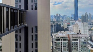 Un immeuble moderne de grande hauteur, doté d’une entrée centrale bien visible et de nombreuses fenêtres.