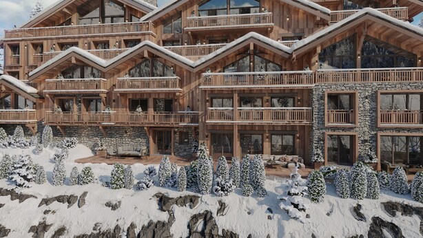 Eine mehrstöckige Holzlodge mit Balkonen und großen Fenstern, umgeben von schneebedeckten Bäumen.