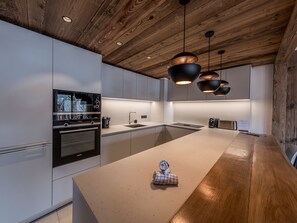 Enjoy cooking in this well-equipped kitchen with a large island, oven, and sink.